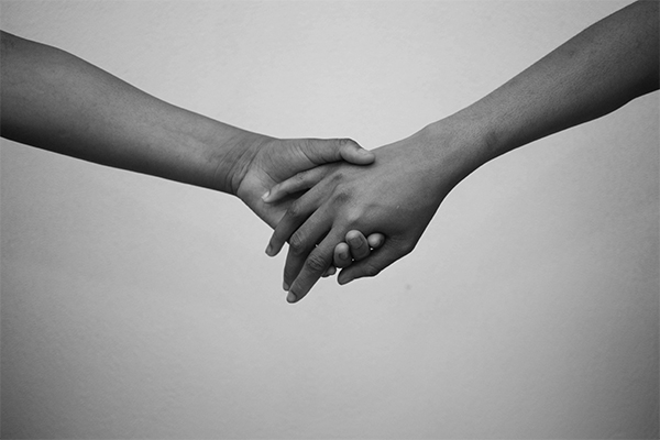 Two people holding hands 